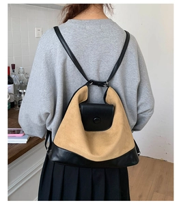 Rear view of model wearing a khaki and black contrast matte backpack with thin straps