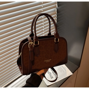 Close-up of leopard print suede and leather stitching on retro brown handbag