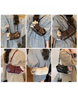 Detail shots of shiny leather shoulder bags with bow pockets and bear charms