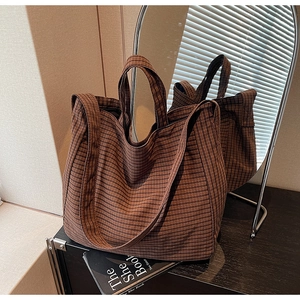 Detailed macro view of retro brown checkered canvas tote bag with textured fabric surface