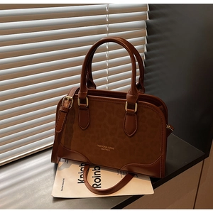 Close-up of leopard print suede and brown leather texture on a retro crossbody bag