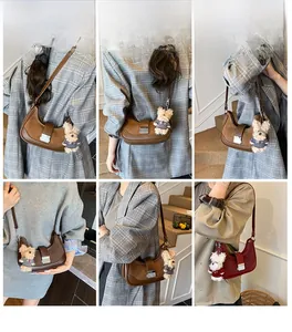 Detail shots of retro saddle shoulder bag with plush bear charm in multiple wearing styles