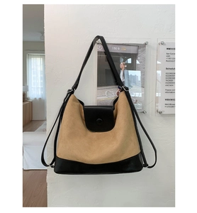 Detail view of the brown and black two-tone tote bag with magnetic flap closure