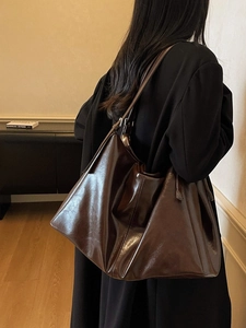 Deep brown vintage glossy leather tote bag with a slouchy design for shoulder wear