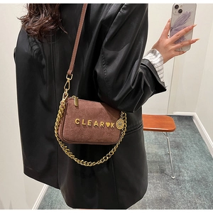 Detail view of brown matte leather shoulder bag with gold chain and CLEAR K lettering