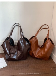Detail of high-gloss synthetic leather tote bags with wavy edges in coffee and caramel
