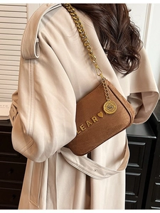 Brown suede crossbody bag with chunky gold chain strap and elegant heart heart decor