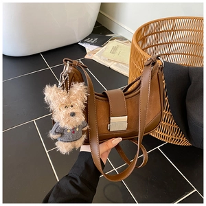 Brown crescent shoulder bag with suede patchwork, silver buckle and cute dog charm