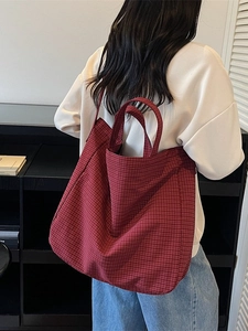 Large red checkered canvas tote bag with dual handles and long shoulder strap