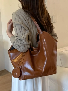 Brown leather tote bag for women with round coin purse charm and wide shoulder strap