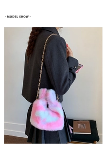Detailed side view of tie-dye plush handbag with gold chain strap on model