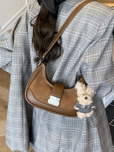 Retro brown half-moon underarm bag in smooth leather with a cute plush dog charm