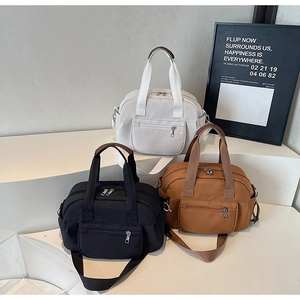 Three casual nylon handbags in black, off-white, and brown with multi-pocket design