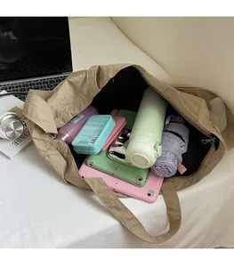 Detail view of the large capacity khaki tote bag showing interior storage space