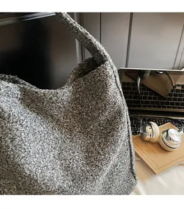 Detail of grey textured teddy fabric on a large tote bag with a cozy fleece aesthetic