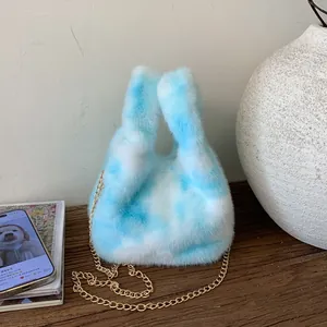 Detailed close-up of blue and white cloud plush bucket bag with golden chain strap