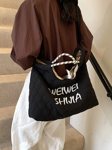 Fashionable black quilted tote bag with woven rope handles for women's daily commute