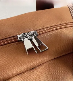 Macro detail of high-quality smooth metal double zippers on waterproof nylon travel bag
