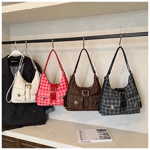 Detail showing four vintage plaid tote bags with front pockets and metal buckles