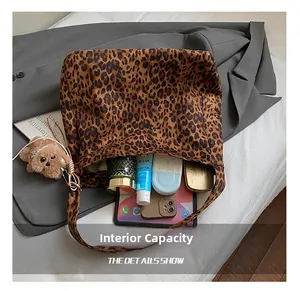 Macro view of leopard print tote bag interior capacity showing tablet and makeup