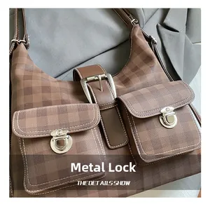 Close-up of vintage brown checkered tote with metallic hardware locks and front pockets
