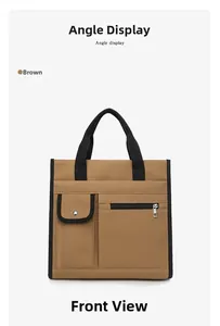 Front view of a brown canvas tote bag featuring black woven handles and metal snap pockets
