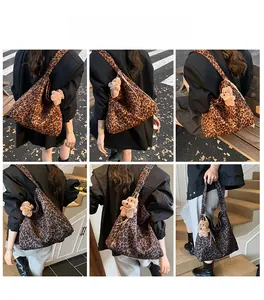 Close-up of leopard print tote bag with plush bear charm and pearls in street style