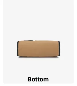 Detailed bottom view of large khaki canvas tote bag with reinforced black webbing edges