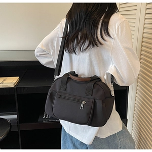 Detailed back view of a versatile black canvas crossbody bag styled with a casual outfit