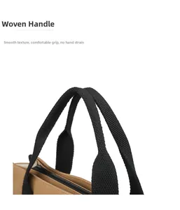 Close-up detail of durable woven handles on a khaki canvas tote bag with zipper