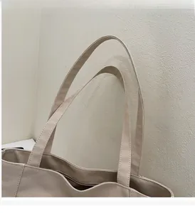Close-up of durable canvas tote bag handles with high-quality reinforced stitching details