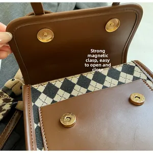 Detail view of strong magnetic snap buttons on retro checkered plaid tote bag closure