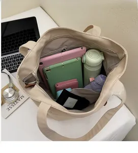 Interior view of beige canvas tote bag showing spacious capacity for tablets and daily items