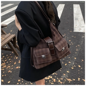 Detail of dark brown checkered tote bag with large capacity and vintage silver buckles