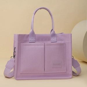 Détail du sac cabas en toile violette avec poches frontales et large bandoulière ajustable