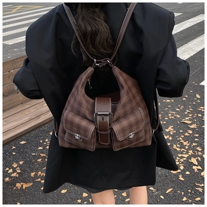 Rear view of a model wearing the brown checkered tote bag in an autumn street setting