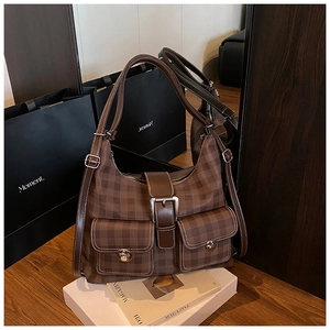 Close-up of vintage brown checkerboard tote with dual front pockets and silver twist locks