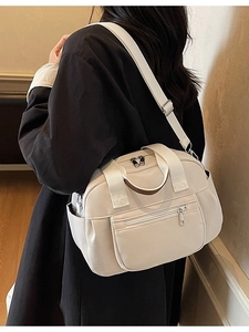 Minimalist beige canvas tote bag with adjustable shoulder strap and multiple pockets