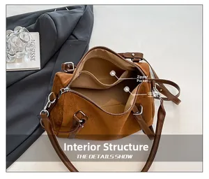 Interior detail of the brown suede Boston bag showing main pocket and zipper compartment
