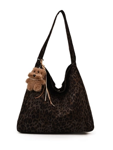Vintage leopard print tote bag with brown plush bear charm and woven tassel details