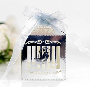 Detailed laser-cut silver candy box with bird pattern and a light blue satin ribbon bow