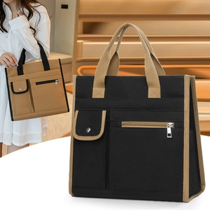 Close-up of canvas tote bag with contrast piping and front metal zipper pocket detail