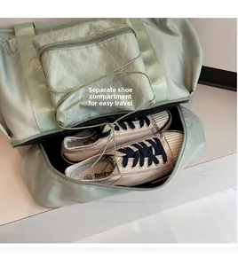 Detail of mint green travel bag featuring a separate bottom shoe compartment