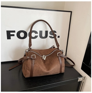 Detail view of dark brown frosted suede Boston bag with silver zipper and shoulder strap