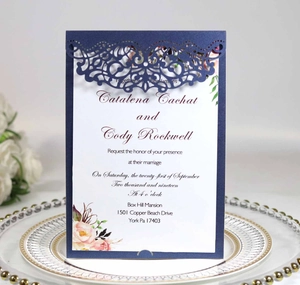 Laser cut hollow wedding invitation in navy blue with elegant pink floral inner card