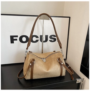 Detail of retro leopard Boston bag featuring matte khaki suede and dark brown leather trim