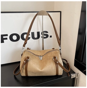 Detail of suede leopard print pillow bag with brown leather straps and silver hardware