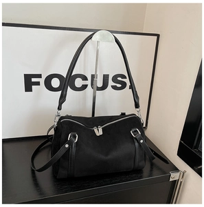 Detailed close-up of a black matte suede Boston bag with double zippers and silver hardware