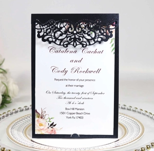 Macro view of laser-cut filigree invitation cover with printed wedding card details