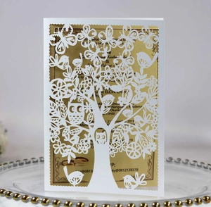 Laser cut Tree of Life invitation card with birds and gold foil insert on glass tray
